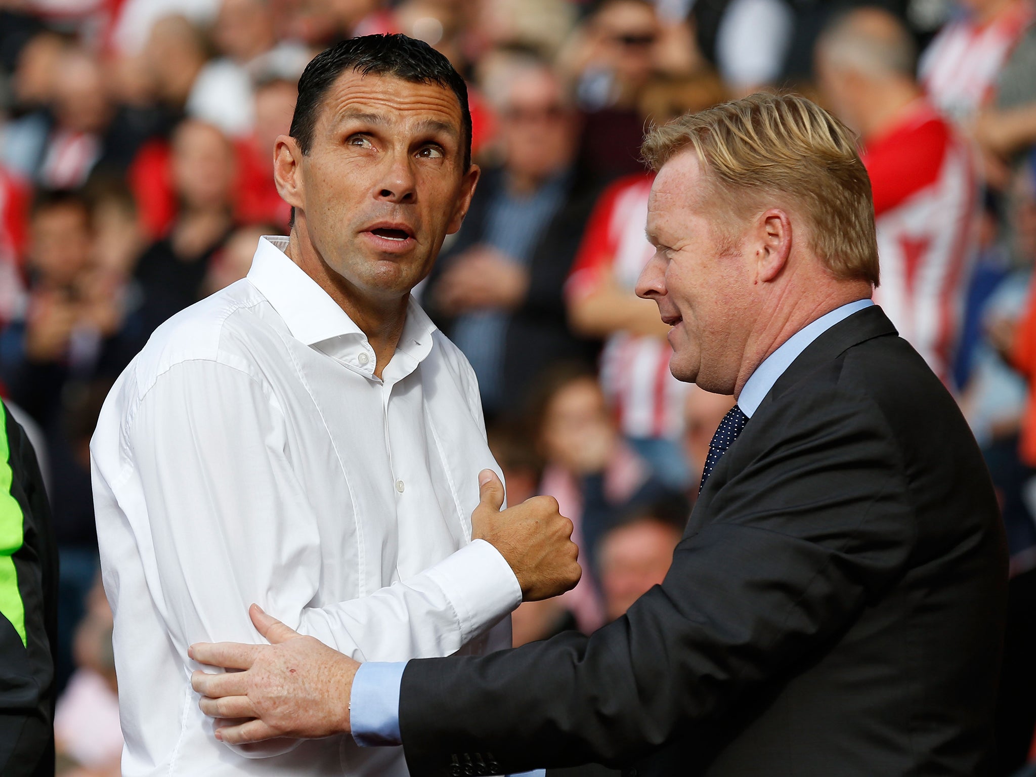 Gus Poyet is consoled by Southampton manager Ronald Koeman after Sunderland’s 8-0 thrashing