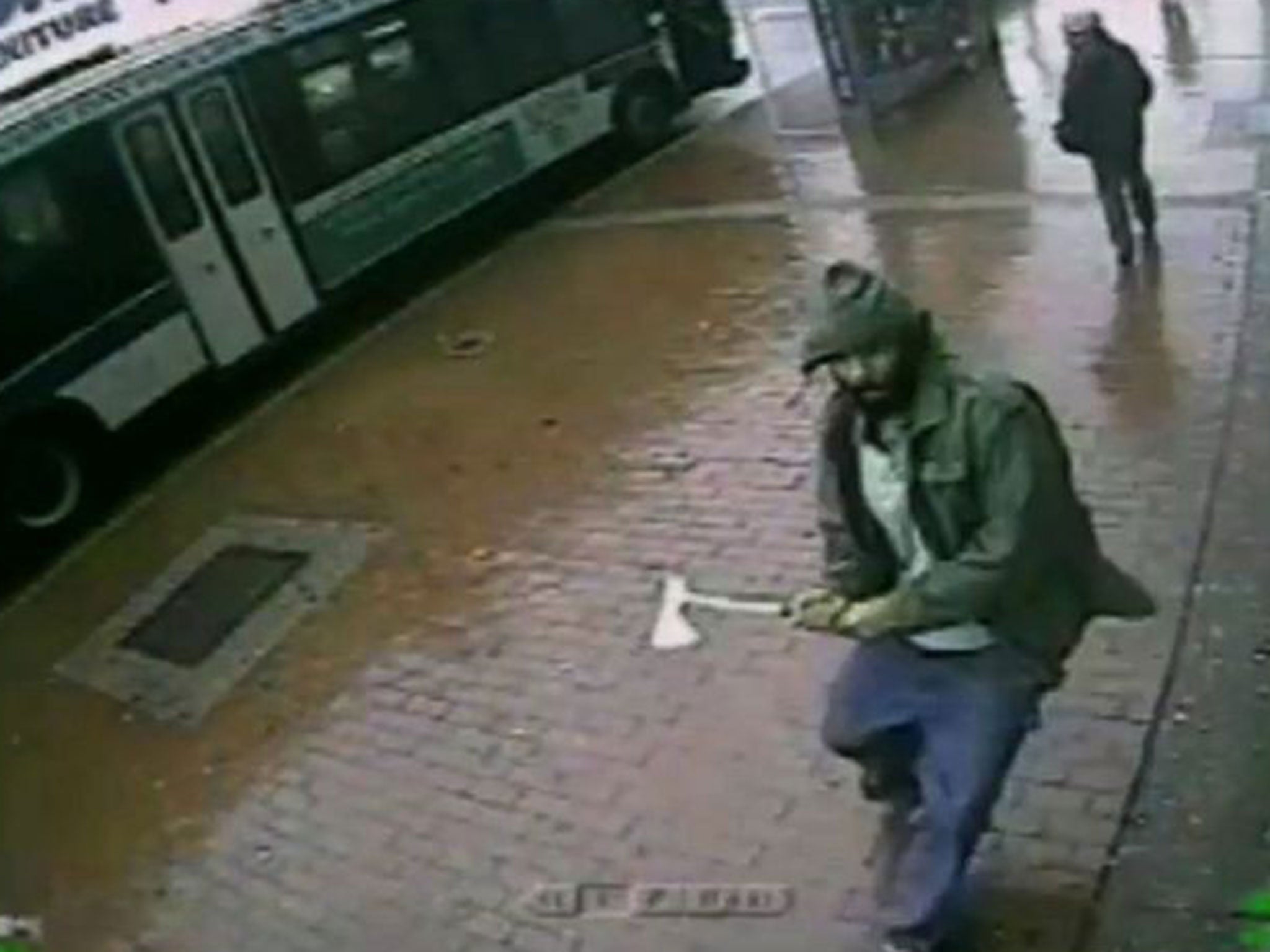 An unidentified man approaches New York City police officers with a hatchet