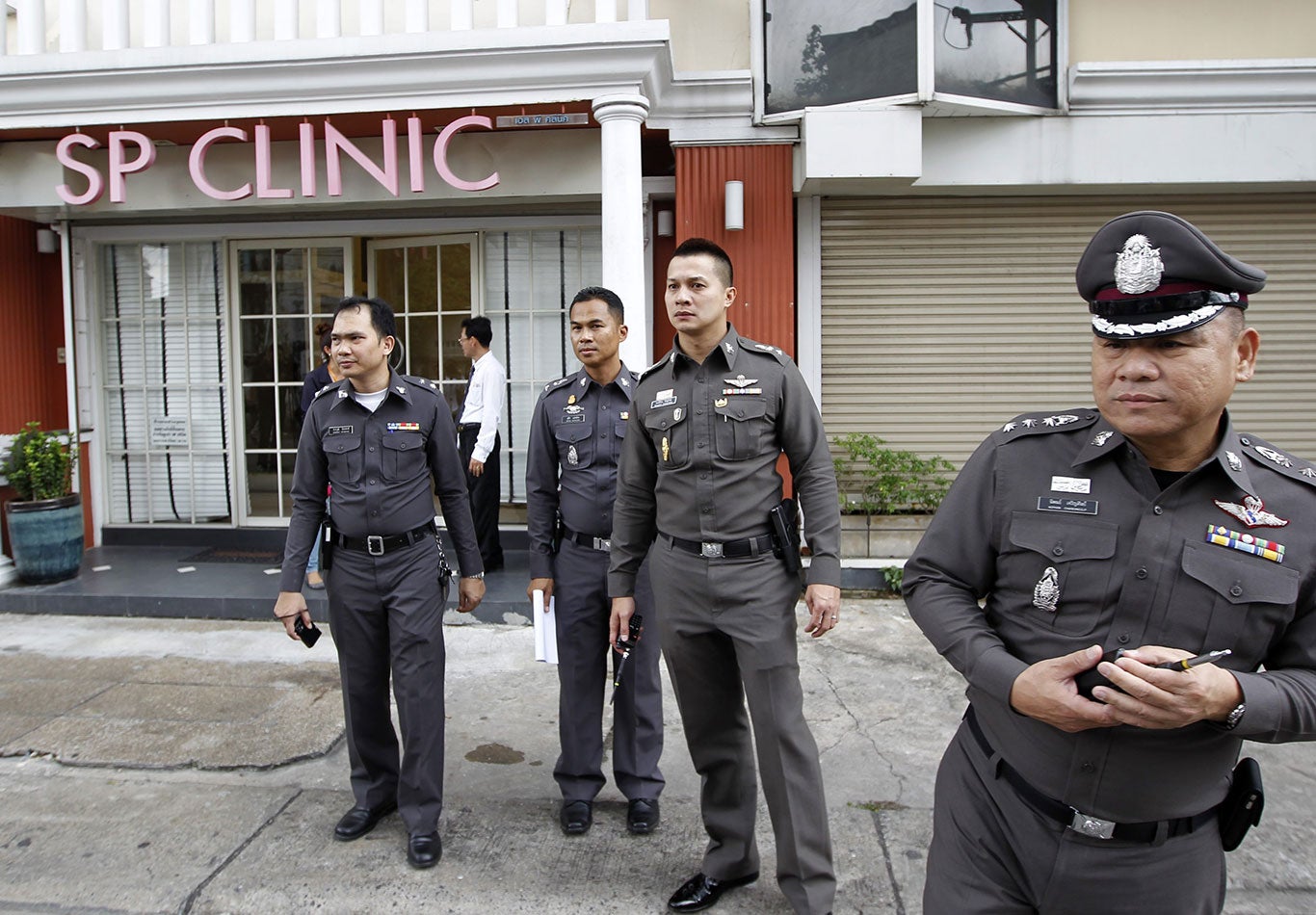 Thai police secure the area during an investigation after a British woman was found dead at a beauty treatment clinic in Bangkok