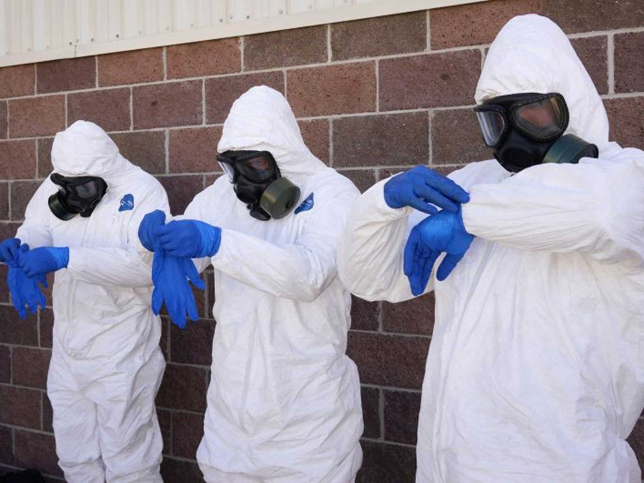 Soldiers from the US Army during personal protective equipment training, as a report critique the DHS' preparations for an outbreak
