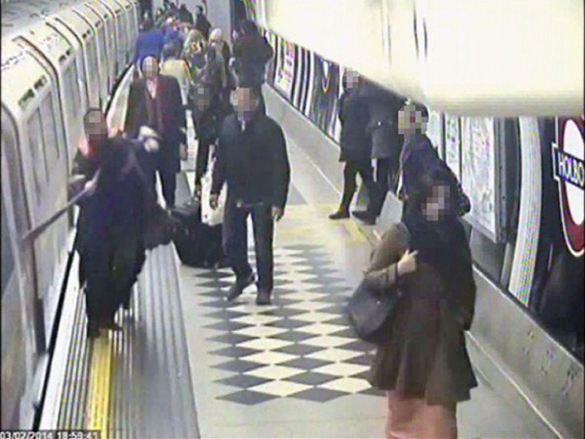 A passenger and their scarf which was trapped in tube train doors, as the train departs from the platform