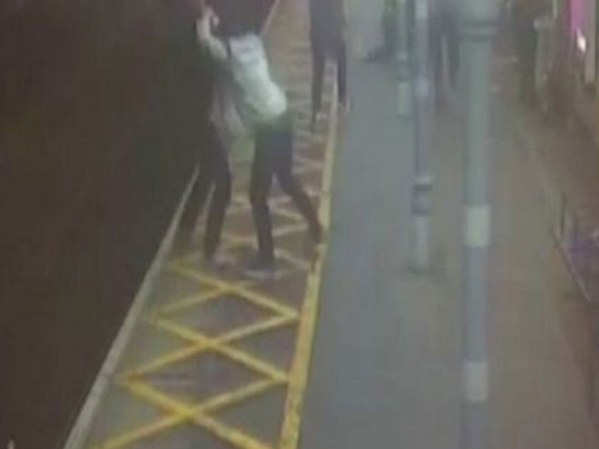 A still taken from CCTV footage of a registered blind man being pushed onto the tracks during a violent assault at a train station.