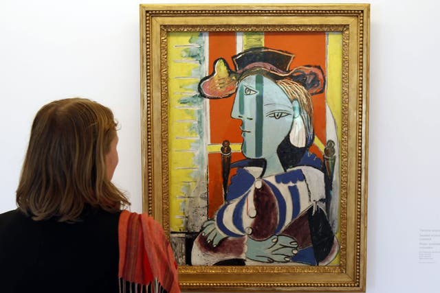 A visitor takes in Seated Woman With Arms Crossed at Musée Picasso