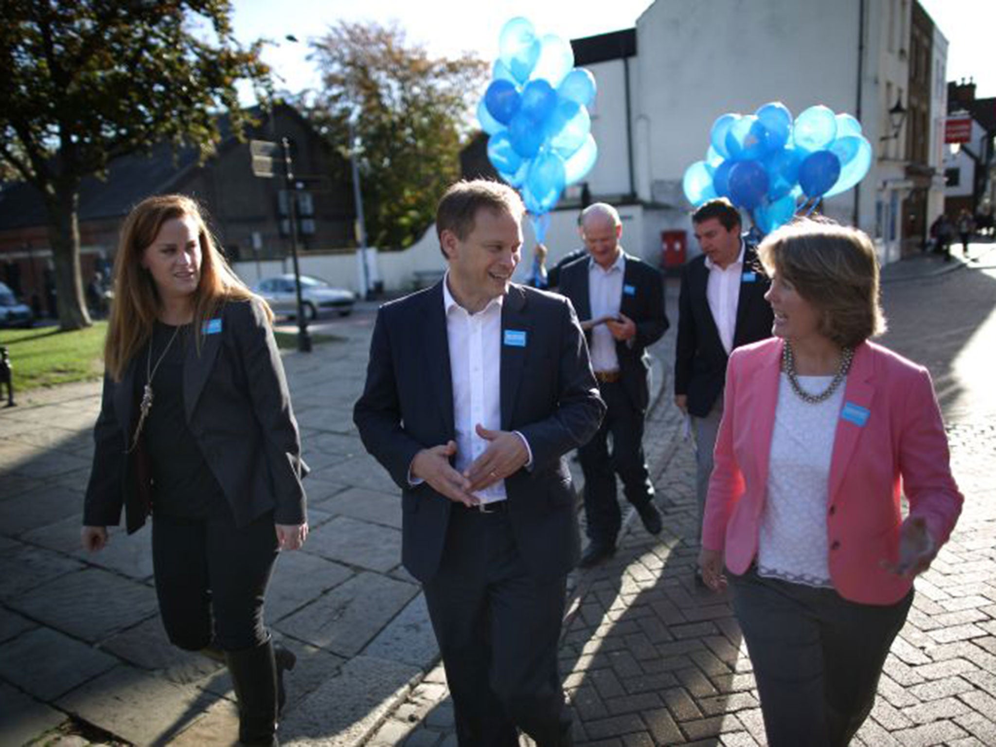 Tory party chairman Grant Shapps campaigns with candidate Kelly Tolhurst, left, and party activists in Rochester