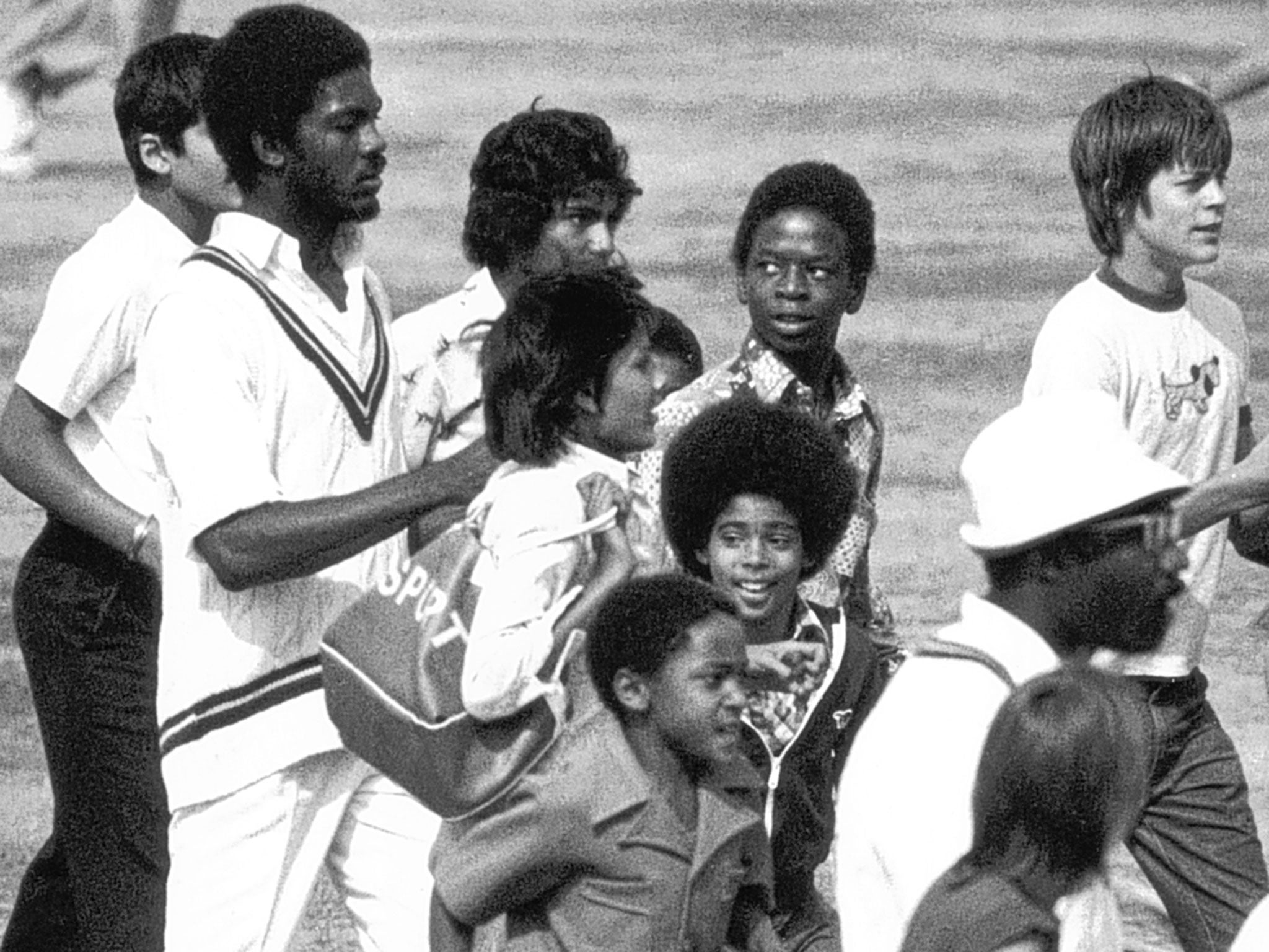 Michael Holding (left) surrounded by jubilant young supporters after his 14 wickets had given West Indies a 231-run win at The Oval in 1976, sealing a 3-0 series victory