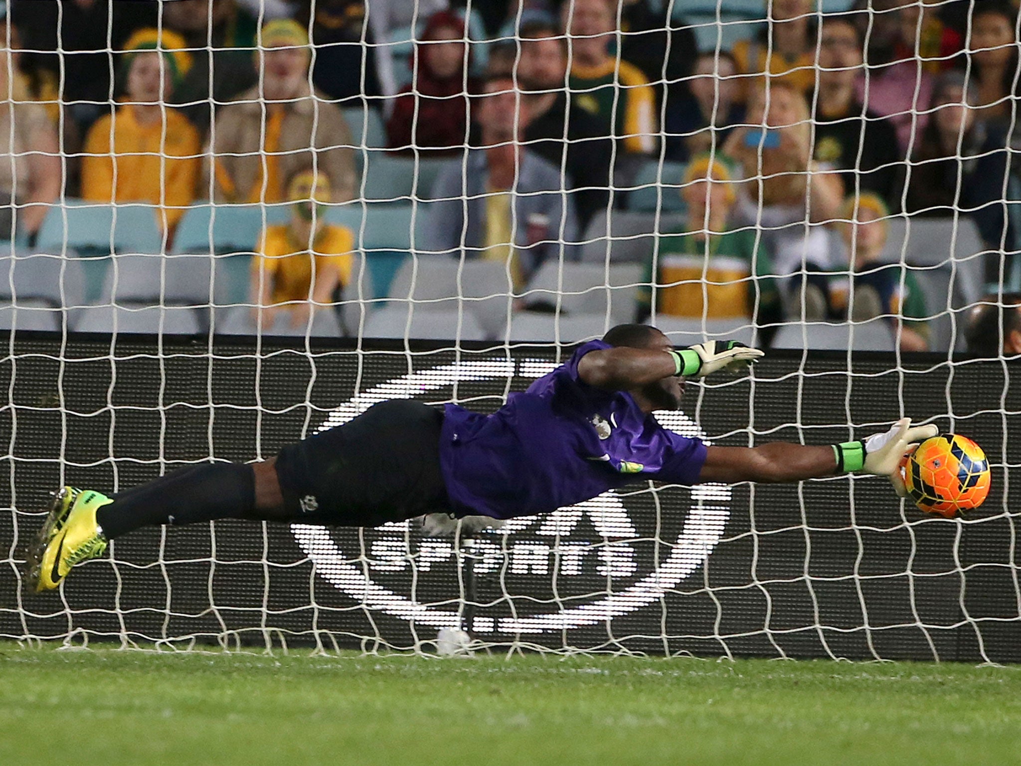 Senzo Robert Meyiwa makes a diving save against Australia during their friendly soccer match in Sydney