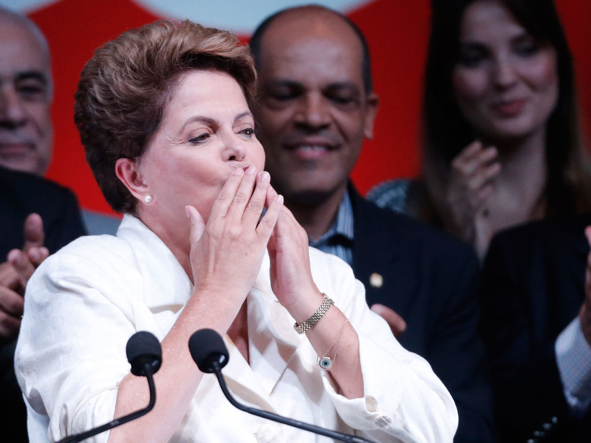 Brazil's President Dilma Rousseff blows kisses to supporters as she celebrates her victory