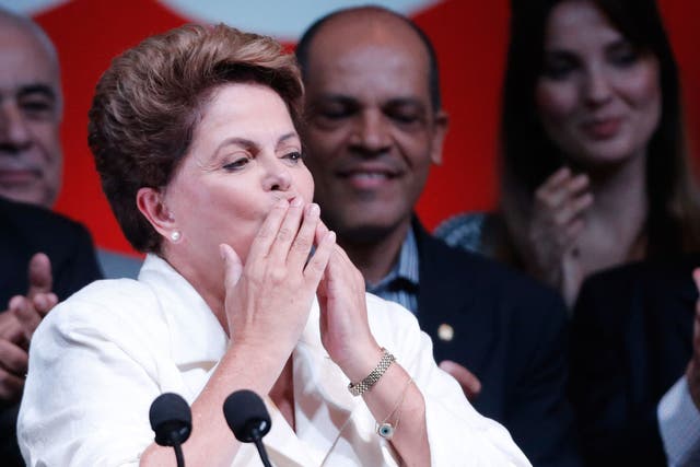 Brazil's President Dilma Rousseff blows kisses to supporters as she celebrates her victory 
