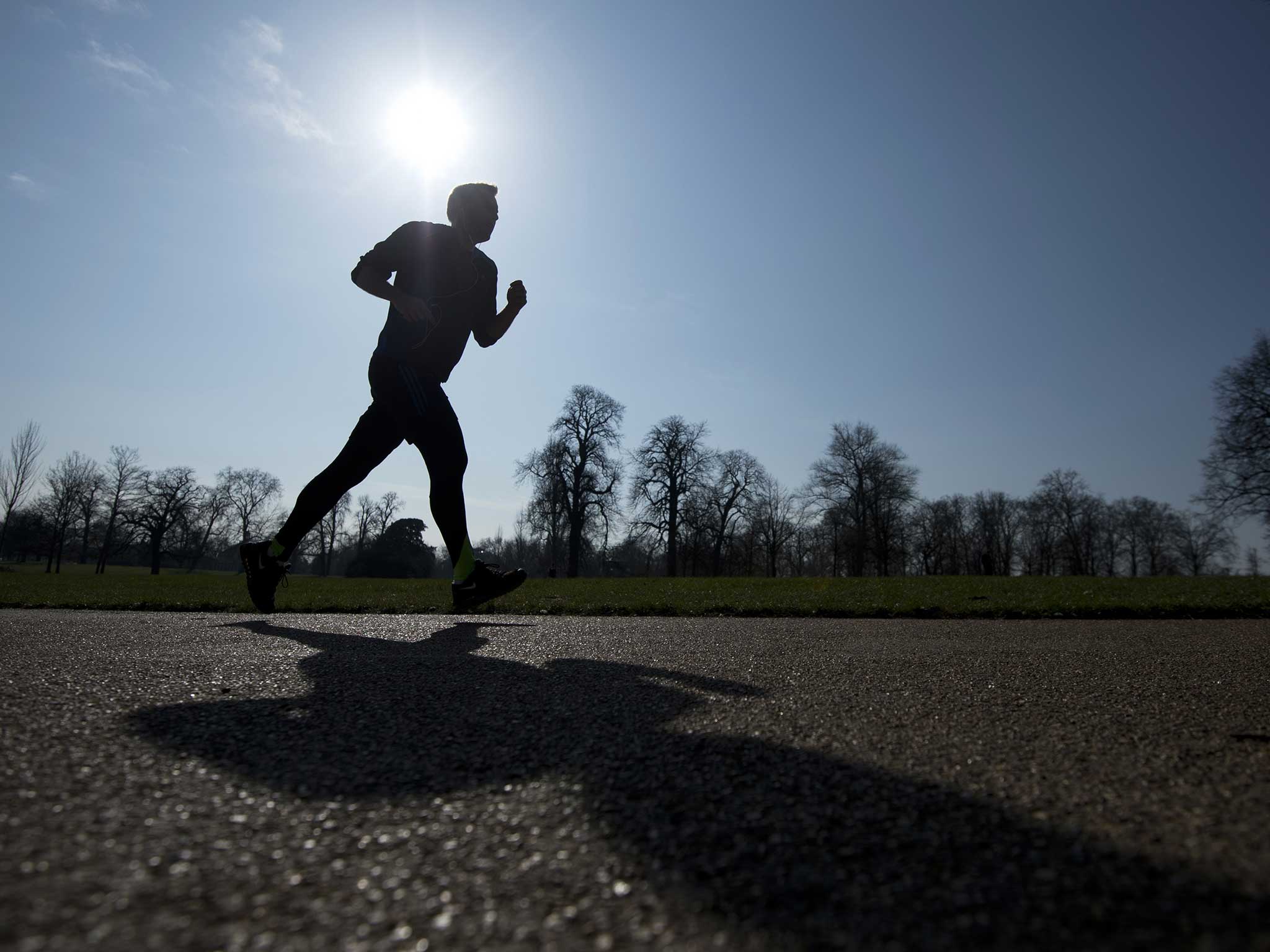 A man runs through Kensington Park Gardens as Londoners wake up to a week of sunshine