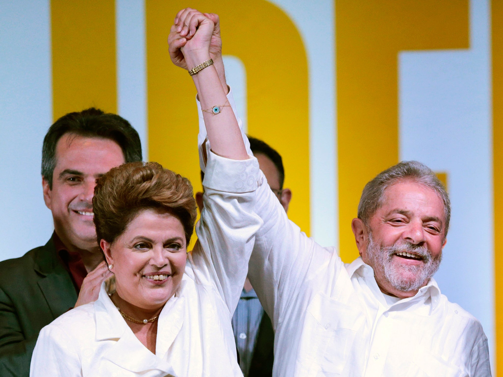 Brazil's President and Workers' Party (PT) presidential candidate Dilma Rousseff (L) and former president Luiz Inacio Lula da Silva celebrate during news conference after disclosure of the election results, in Brasilia. Rousseff narrowly won re-election a