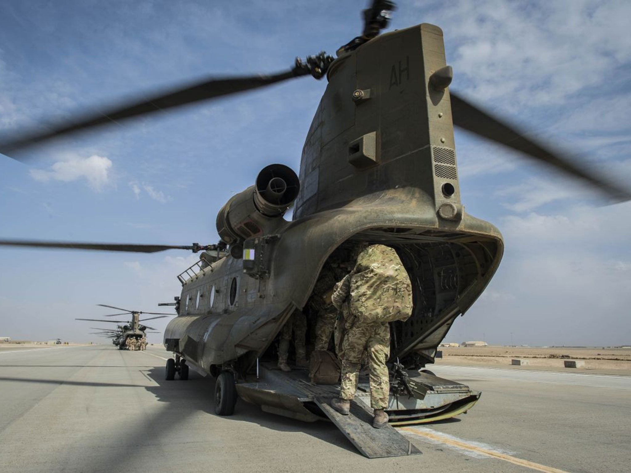 Wing Commander Matt Radnall, Officer Commanding 7 Force Protection Wing, boards the last Chinook helicopter as the very last British boots to leave Camp Bastion,