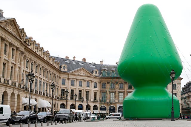 A sculpture entitled 'Tree' by US artist Paul McCarthy is on display at the Place Vendome in Paris, France, 16 October 2014. The 24.4 meter high piece is shown publicly as part of Paul McCarthy's exhibition 'Chocolate Factory' held at the Monnaie de Paris