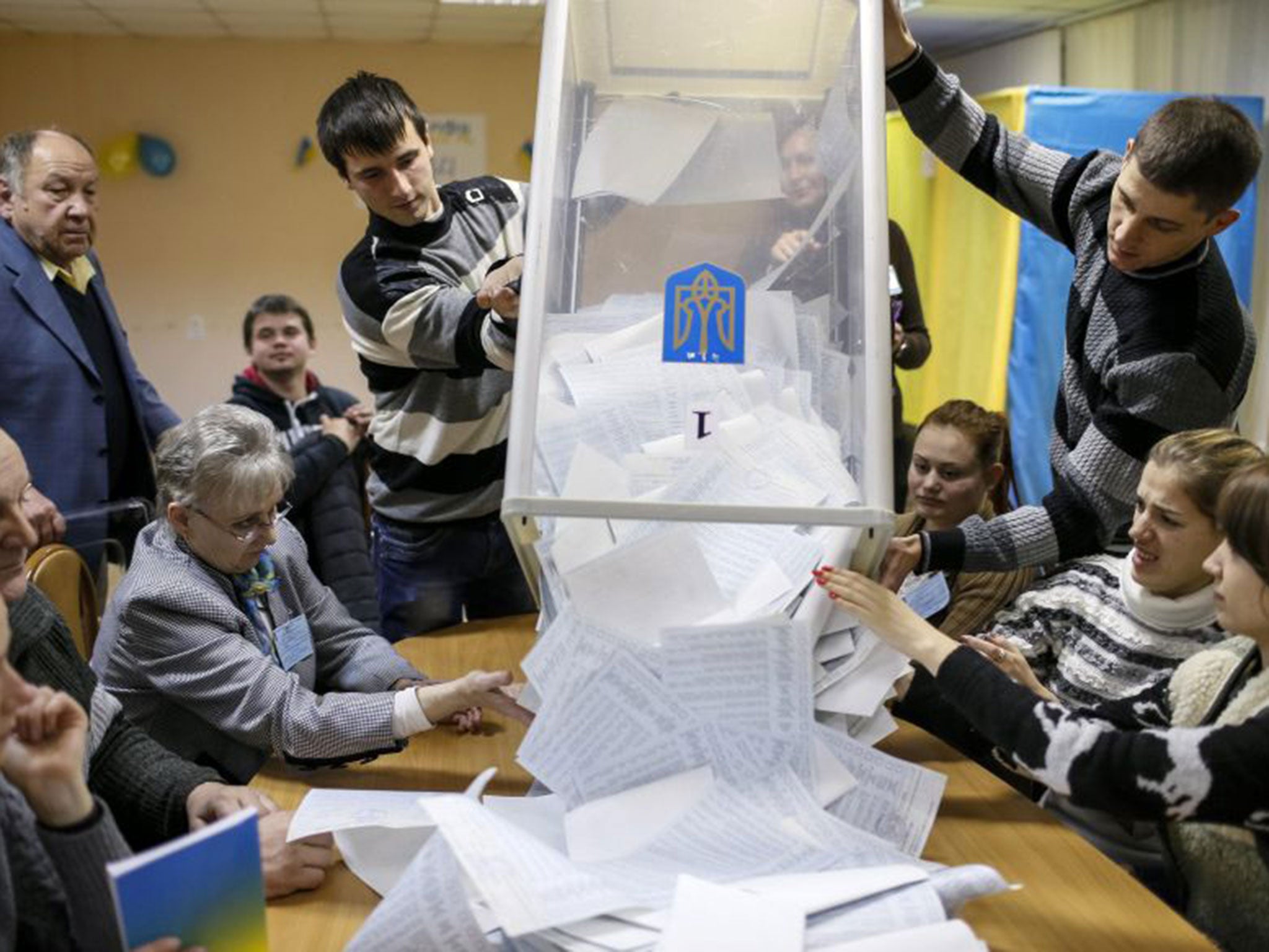 Members of a local electoral commission empty a ballot box at a polling station after voting day in Kiev on 26th October. 36 million Ukrainian people were registered to vote