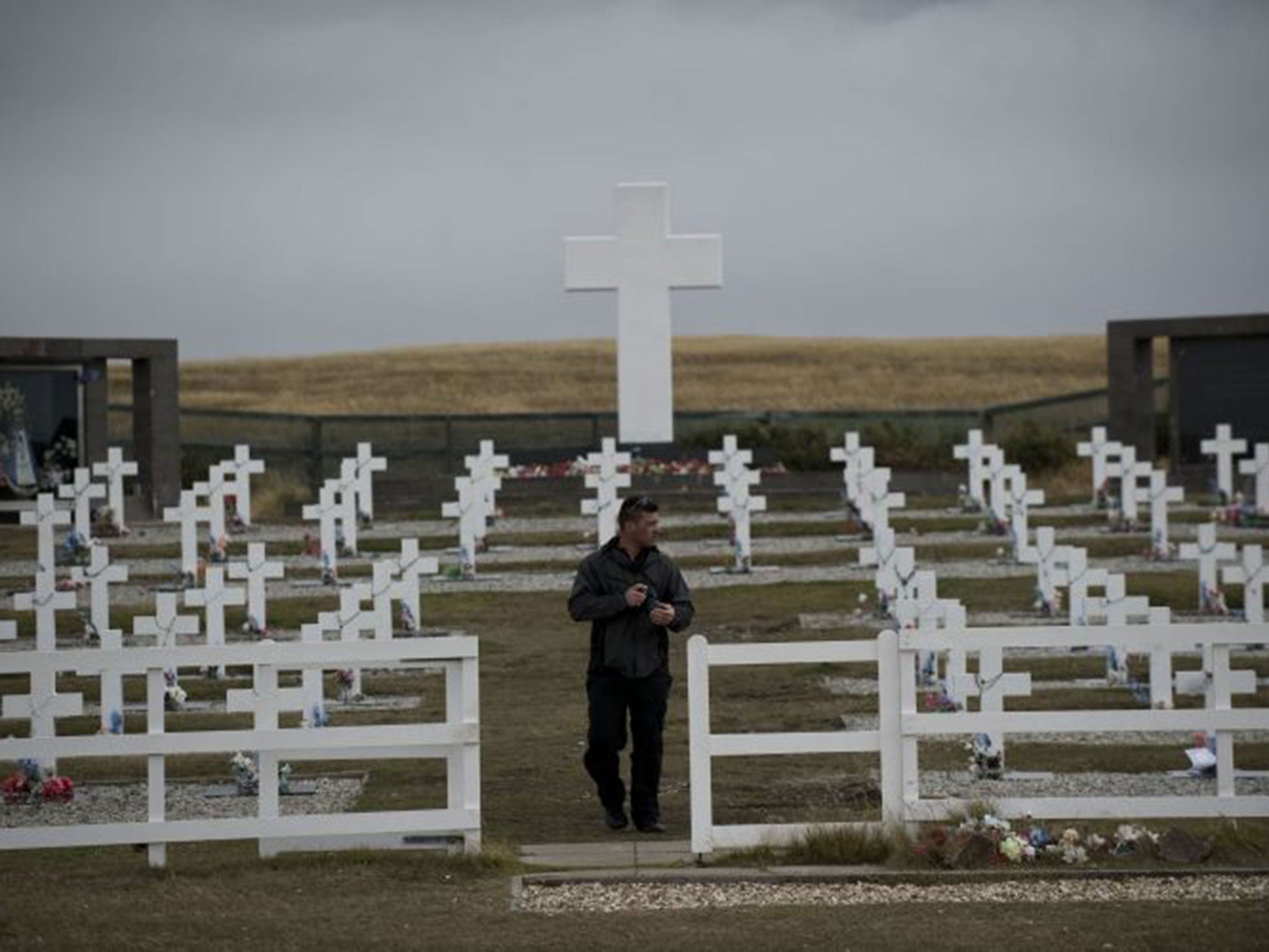 Sebastian Socodo (in charge of cemetery maintenance) walks among the tombstones at the Argentine cemetery in the Falkland Islands