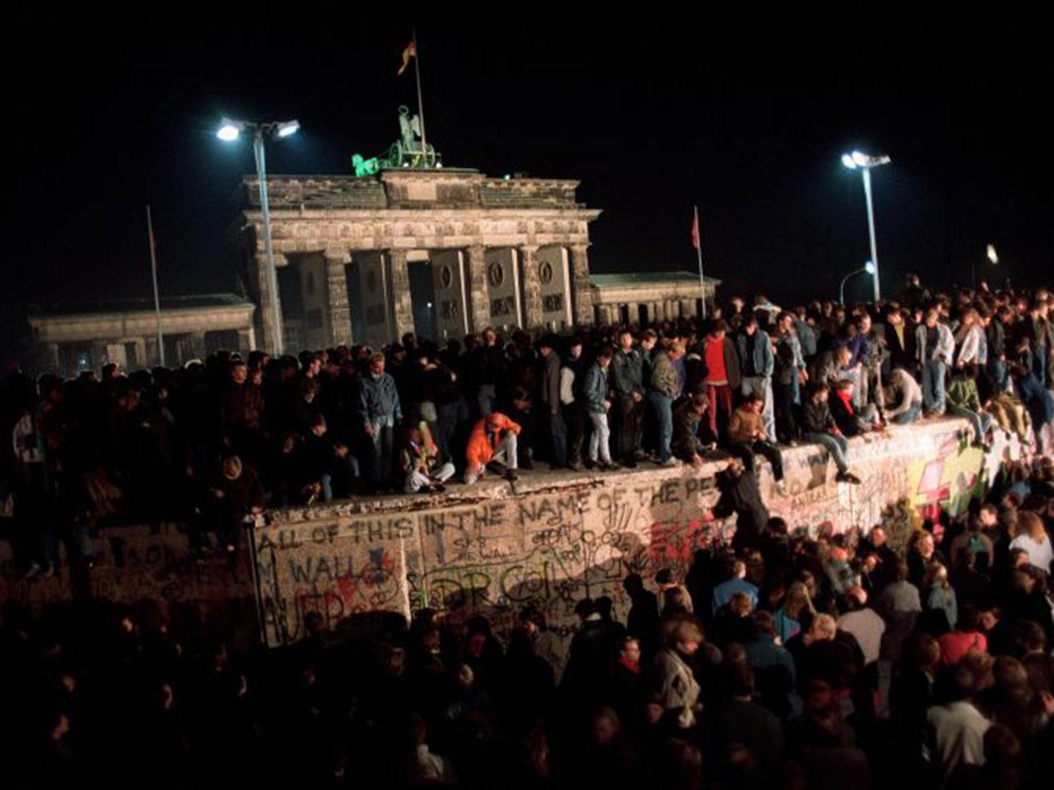 Thousands of young East Berliners gather at the Berlin Wall, near the Brandenburg Gate on November 11, 1989 (AFP/Getty Images)