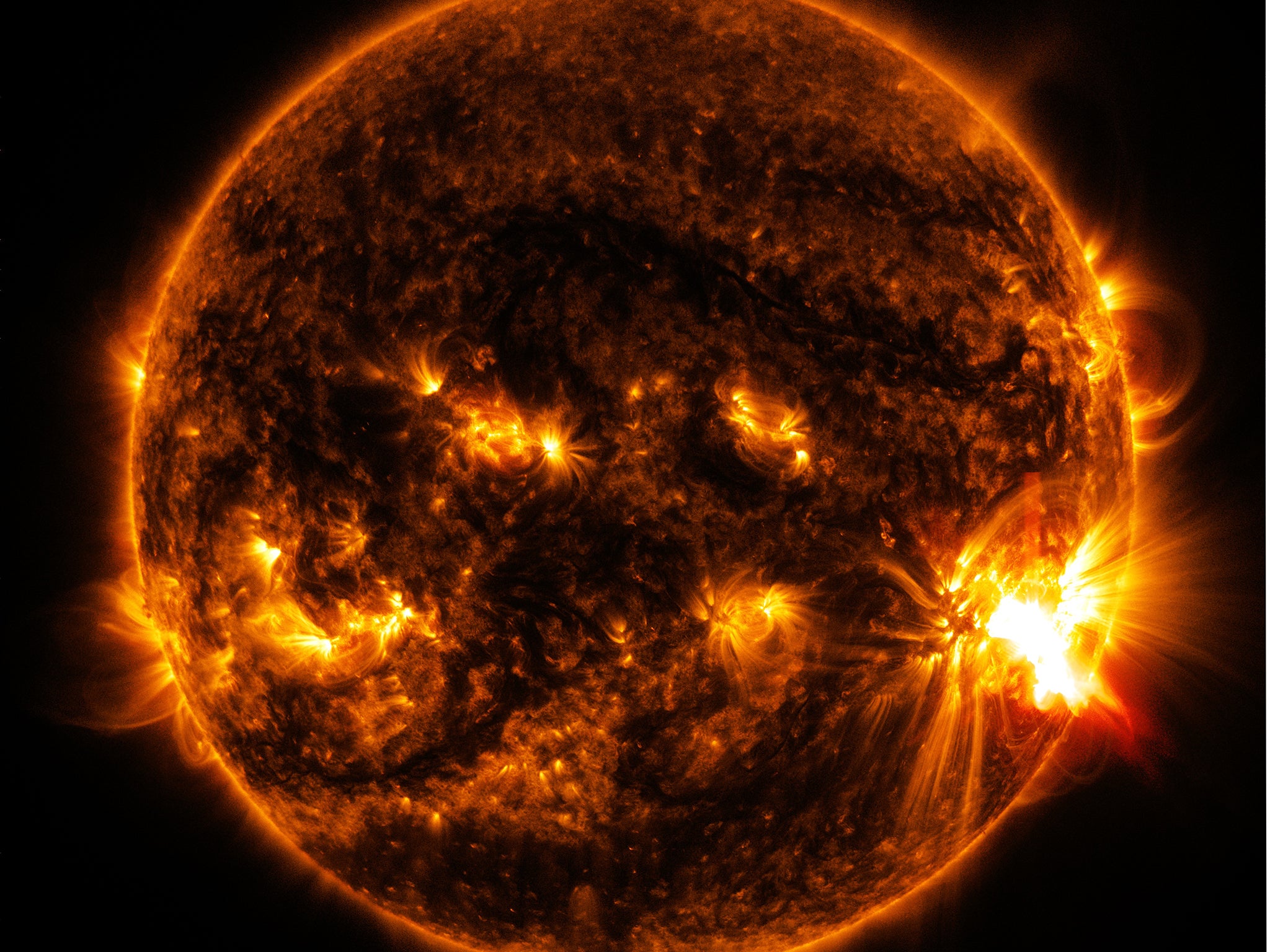 The bright light in the lower right of the sun shows an X-class solar flare on Oct. 26, 2014, as captured by NASA's SDO.