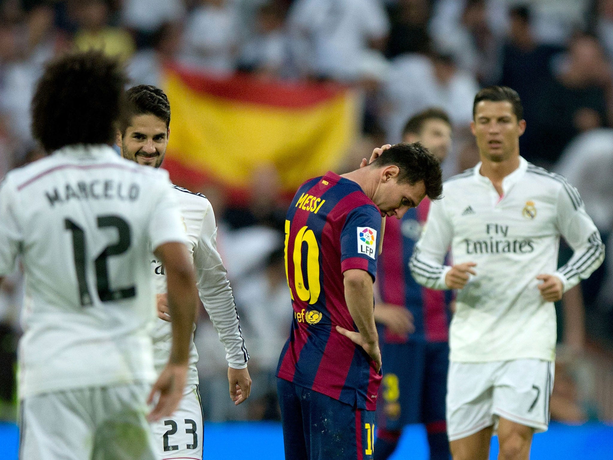 Real Madrid players Marcelo, Isco and Ronaldo celebrate as Messi looks dejected