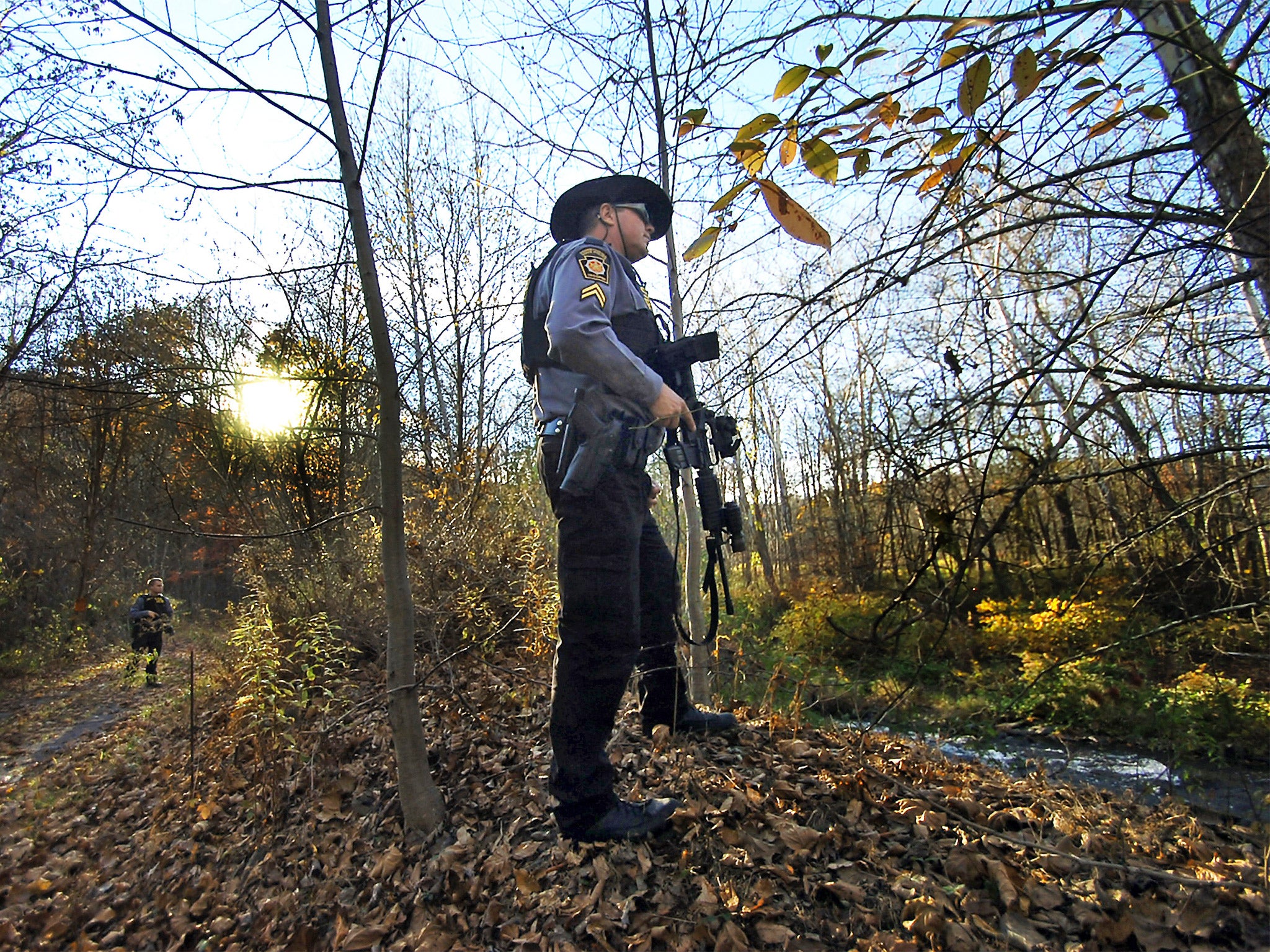 Pennsylvania State Troopers search the woods near Route 191 in Henryville