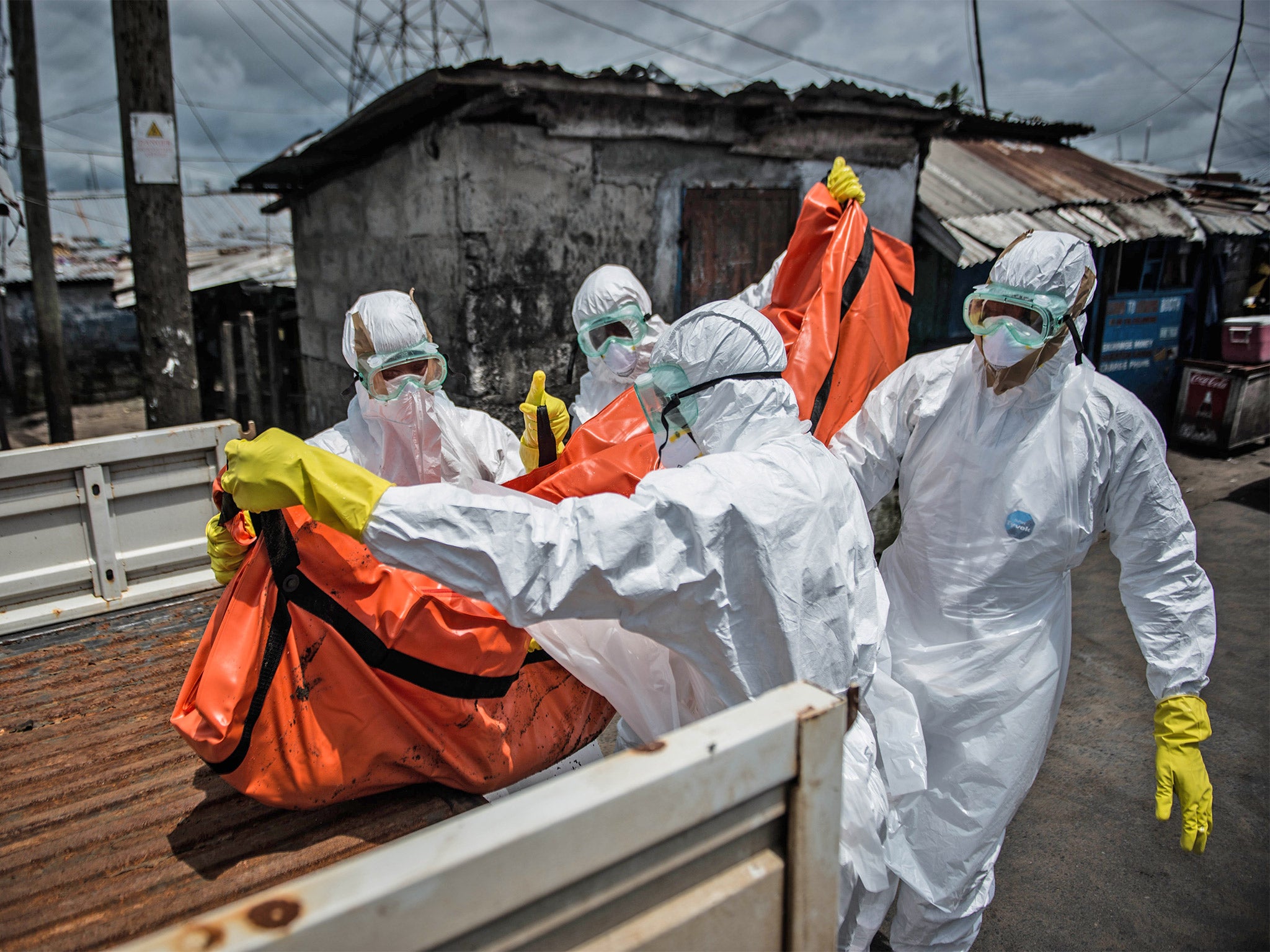 Red Cross members carry the body of an Ebola victim in Monrovia, Liberia, earlier this month