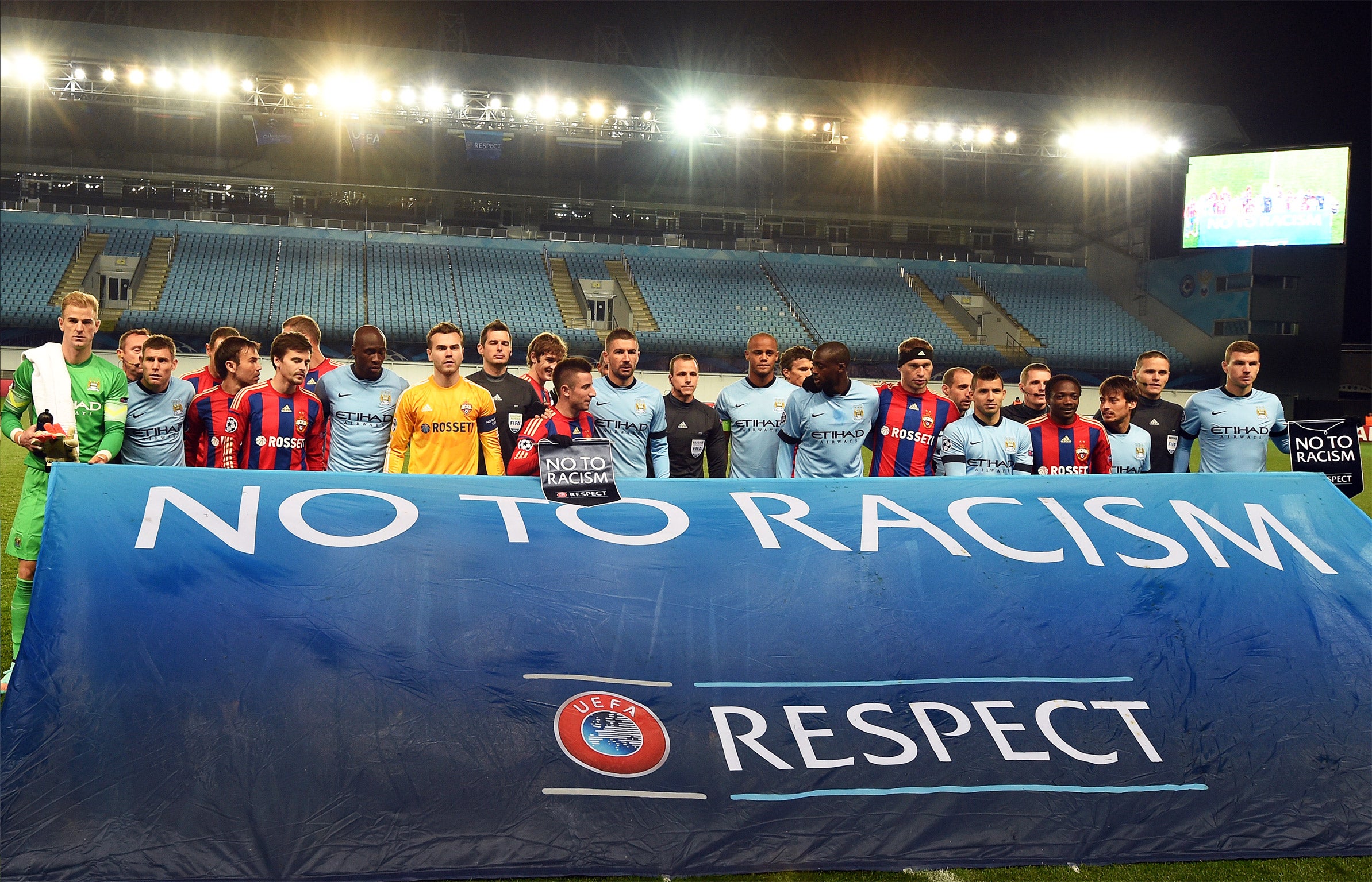 Manchester City and CSKA Moscow players stand behind a banner in support of UEFA's anti-racism campaign before their Champions League match - which was played in front of empty stands - in Russia earlier this month