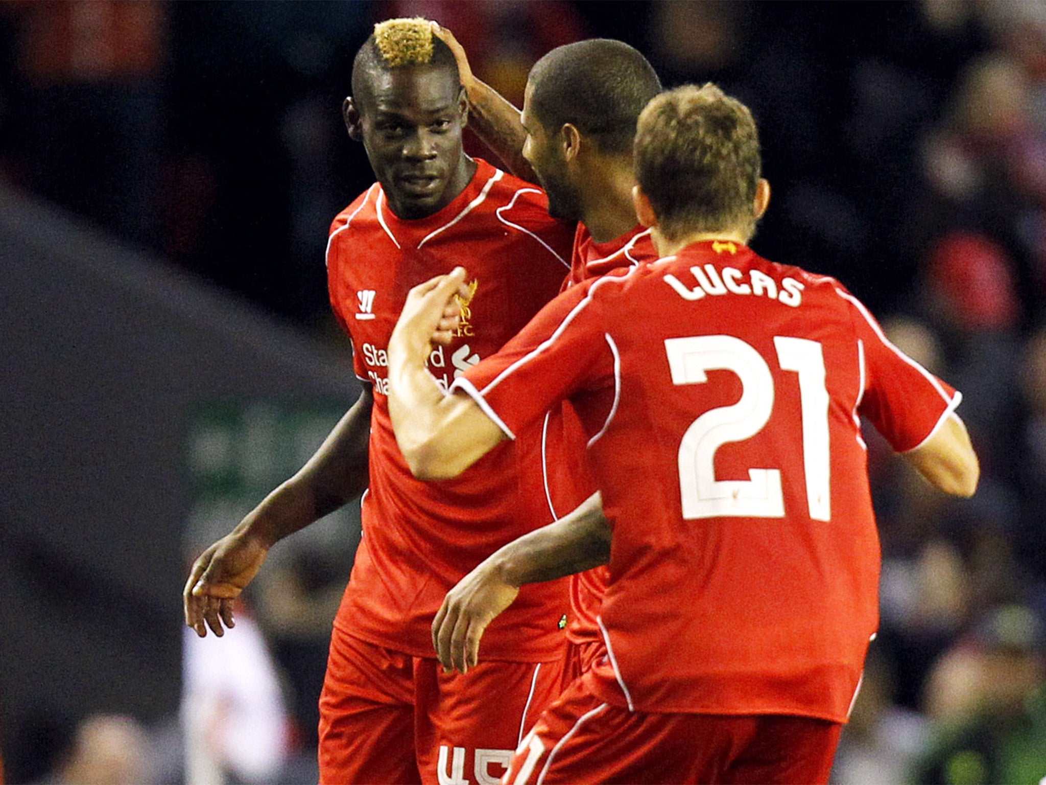 Mario Balotelli is congratulated after scoring the equaliser as Liverpool fought back to beat Swansea 2-1 in the Capital One Cup