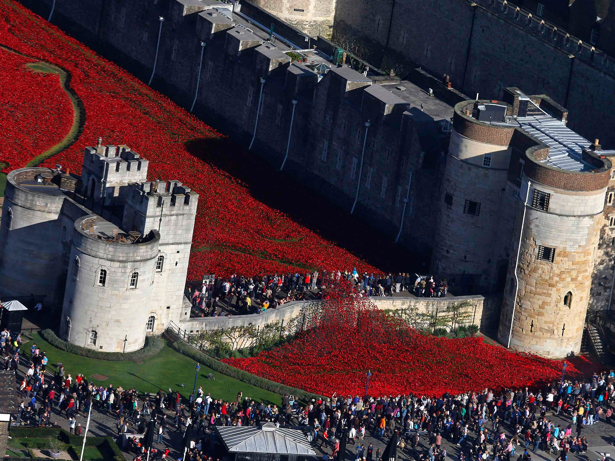 Crowds gather to see the red ceramic poppies that form part of the art installation "Blood Swept Lands and Seas of Red" at the Tower of London in London
