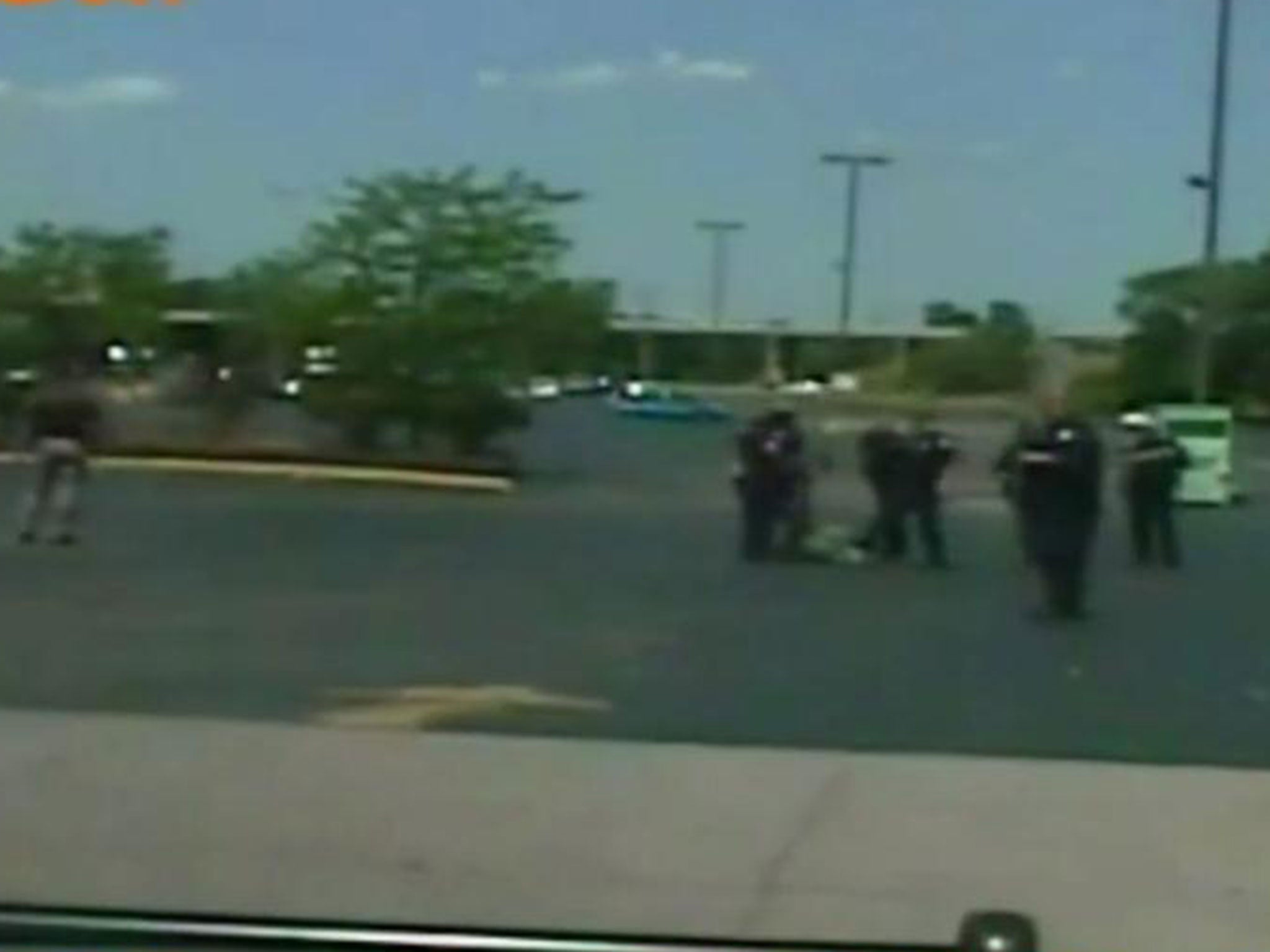 Police officers attempting to handcuff Mr Hall after shooting him