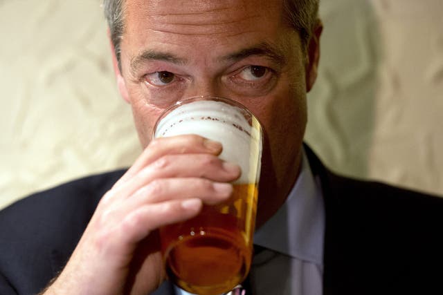 Nigel Farage enjoys a pint of beer after unveiling campaign posters ahead of the Heywood and Middleton by-election