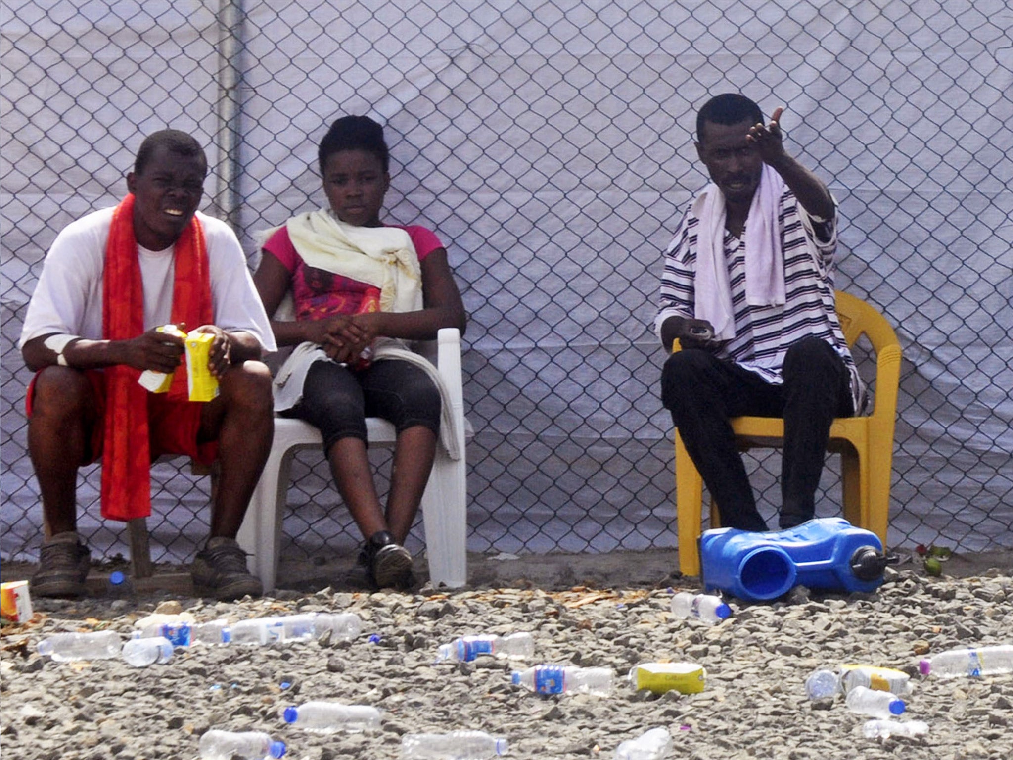 Ebola patients sit inside the Island Clinic Treatment center, where they are kept under quarantine, in Monrovia, Liberia