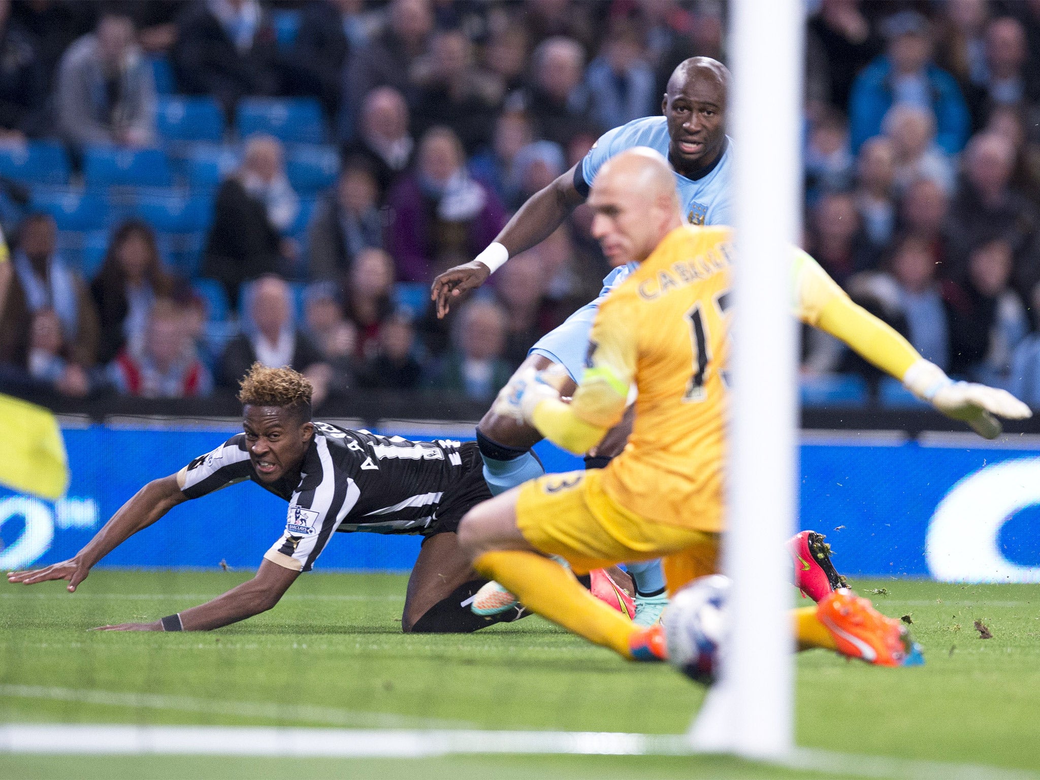 Rolando Aarons watches as his effort finds the corner of the Manchester City goal to give Newcastle the lead