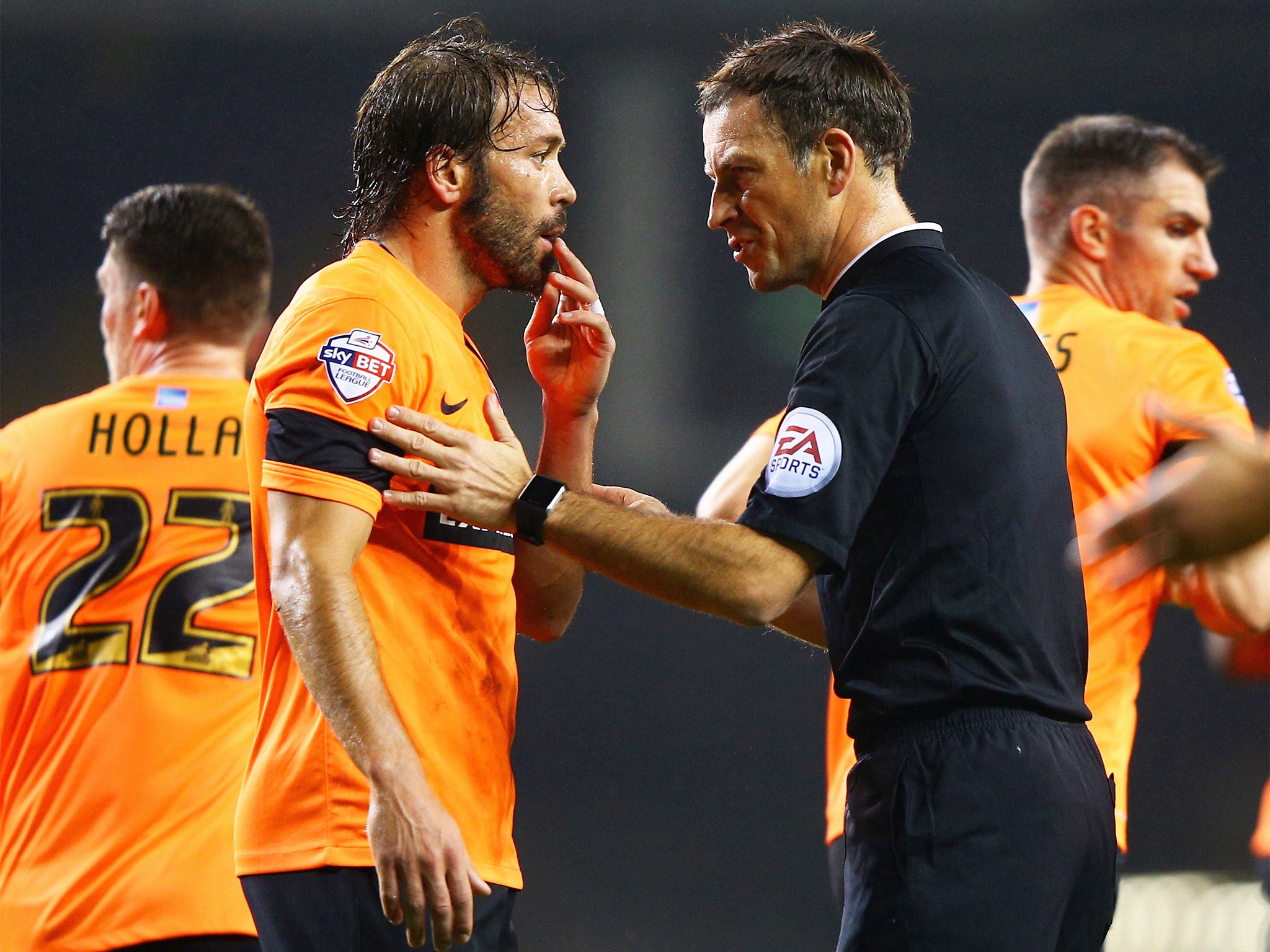 Referee Mark Clattenburg gives Brighton's Inigo Calderon a talking to