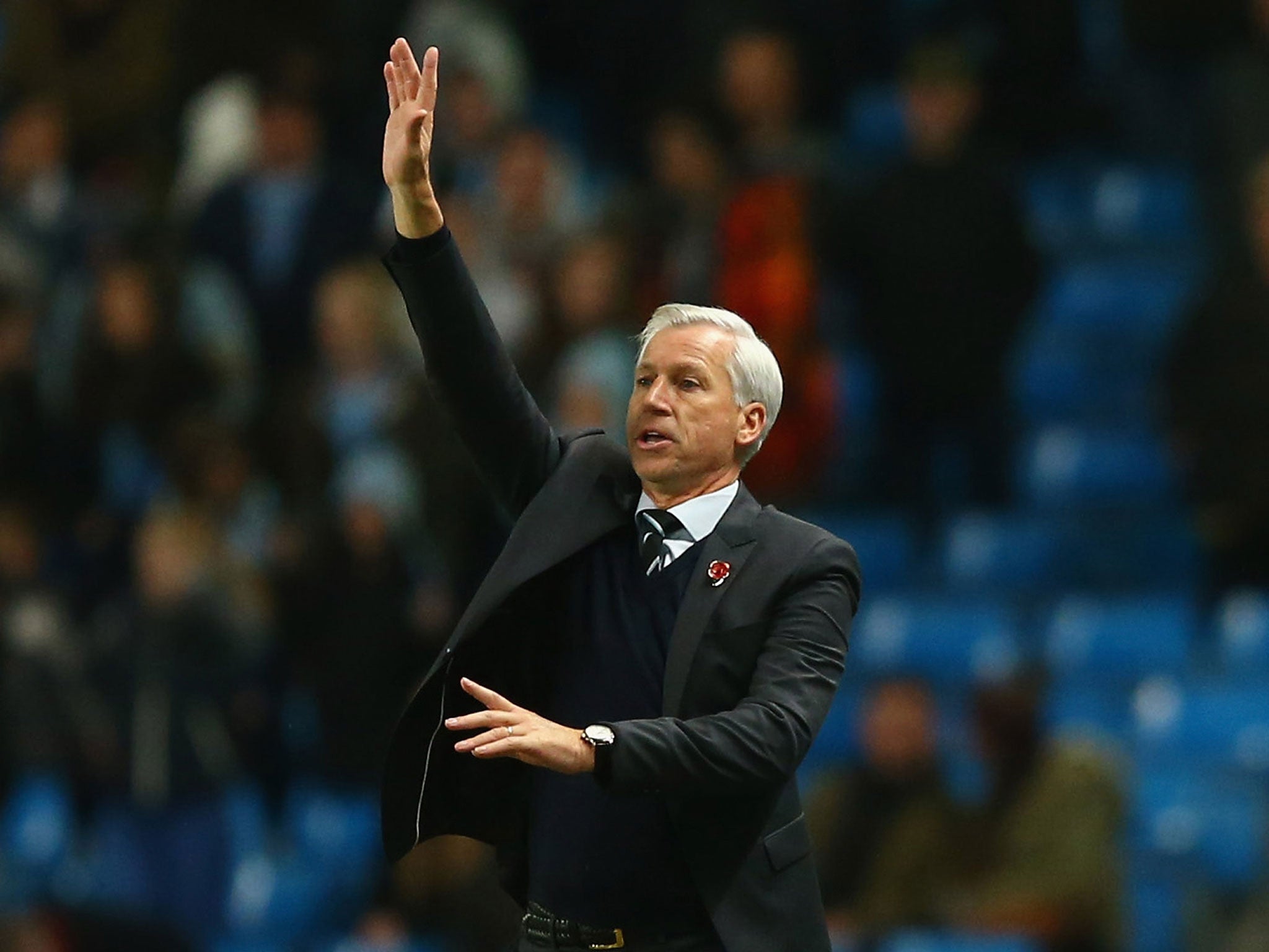 Alan Pardew makes a gesture on the touchline