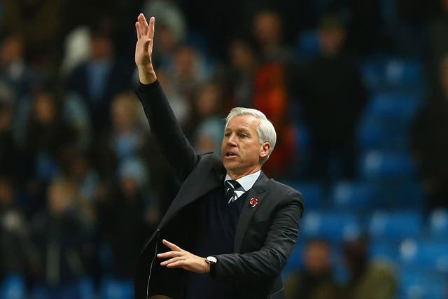 Alan Pardew makes a gesture on the touchline