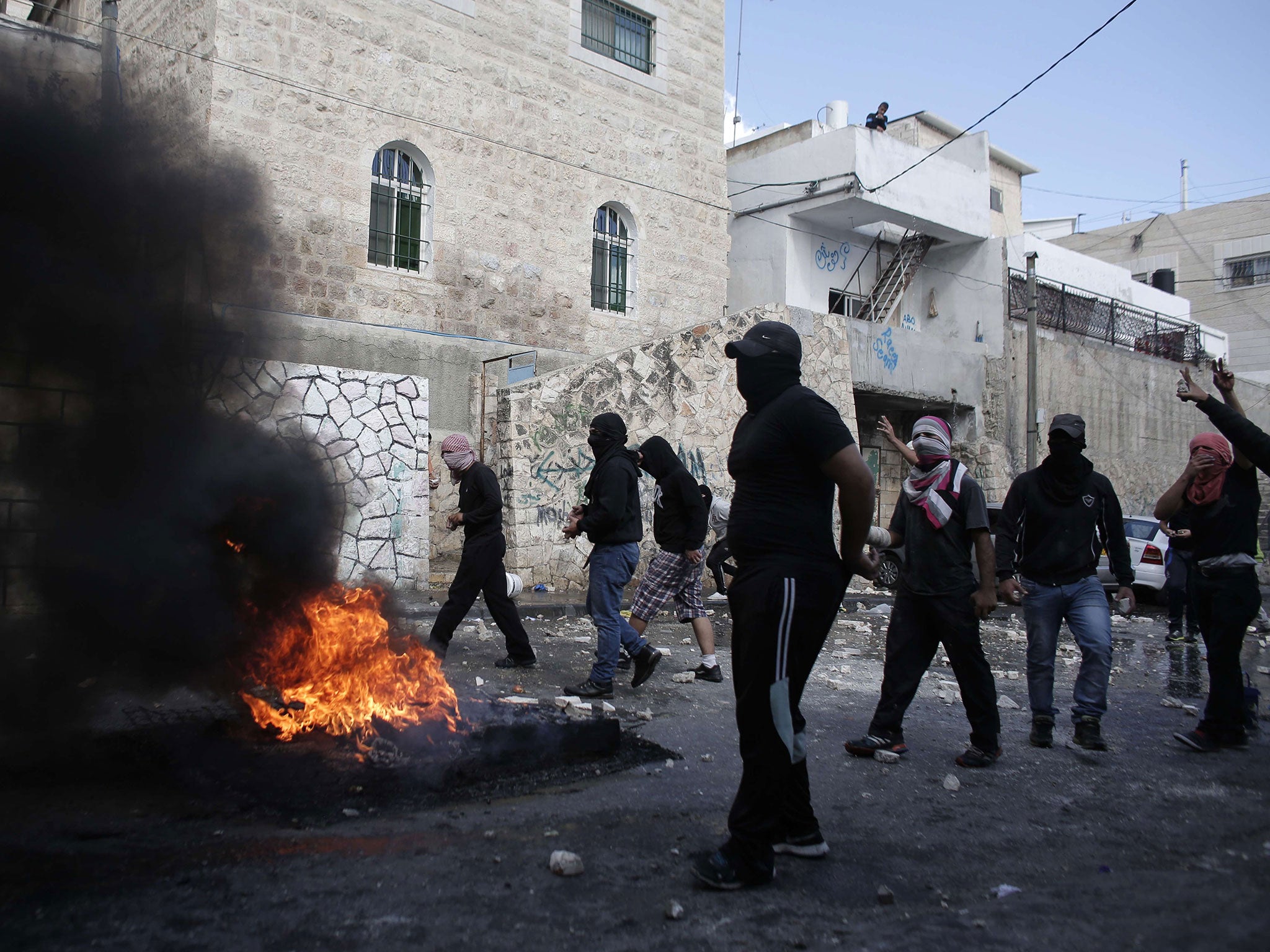 Masked Palestinian youths clash with Israeli security forces in the East Jerusalem neighbourhood of Abu Tor on Thursday, October 30