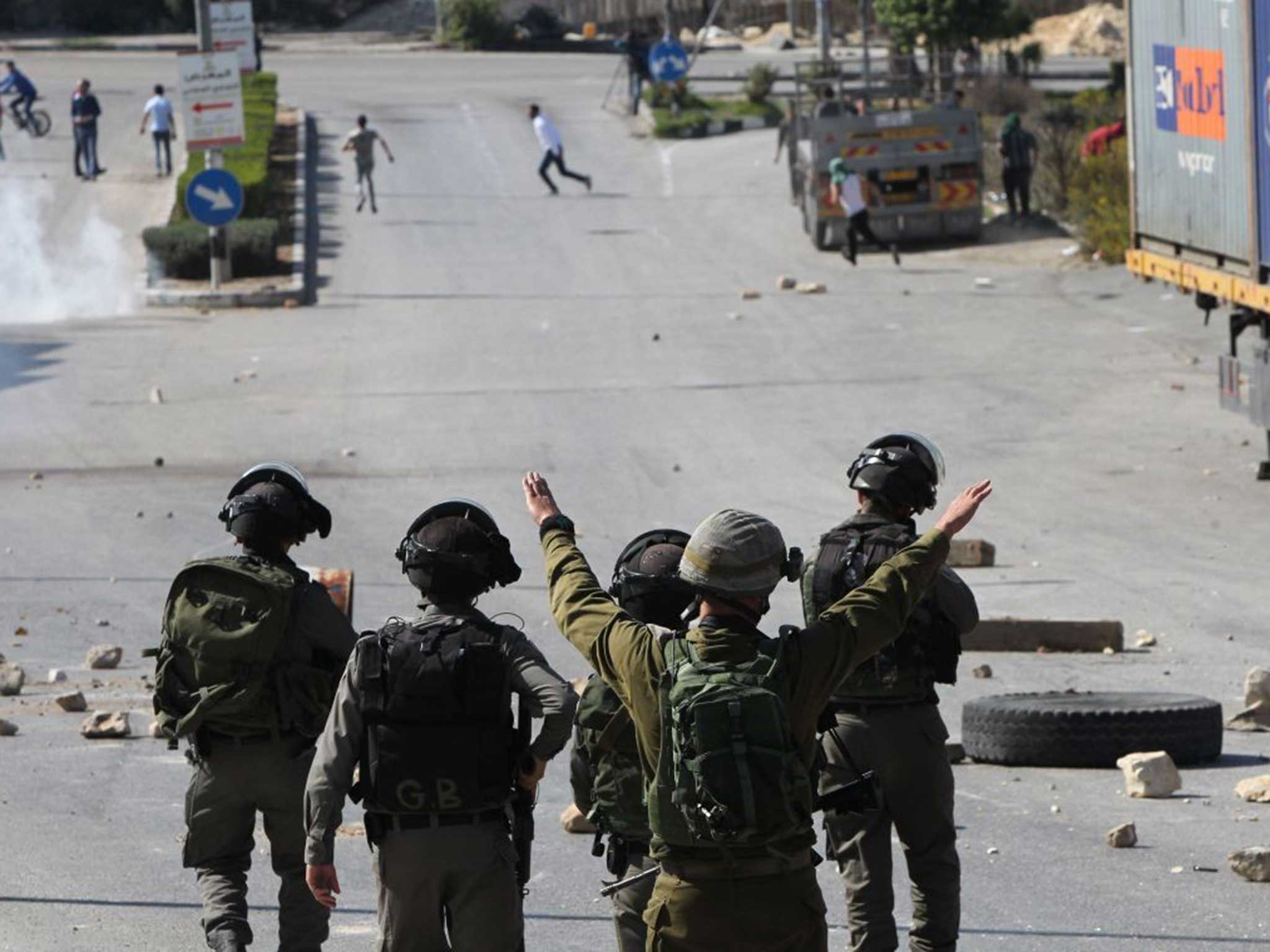 IDF soldiers clear a street during a Palestinian demonstration last week
