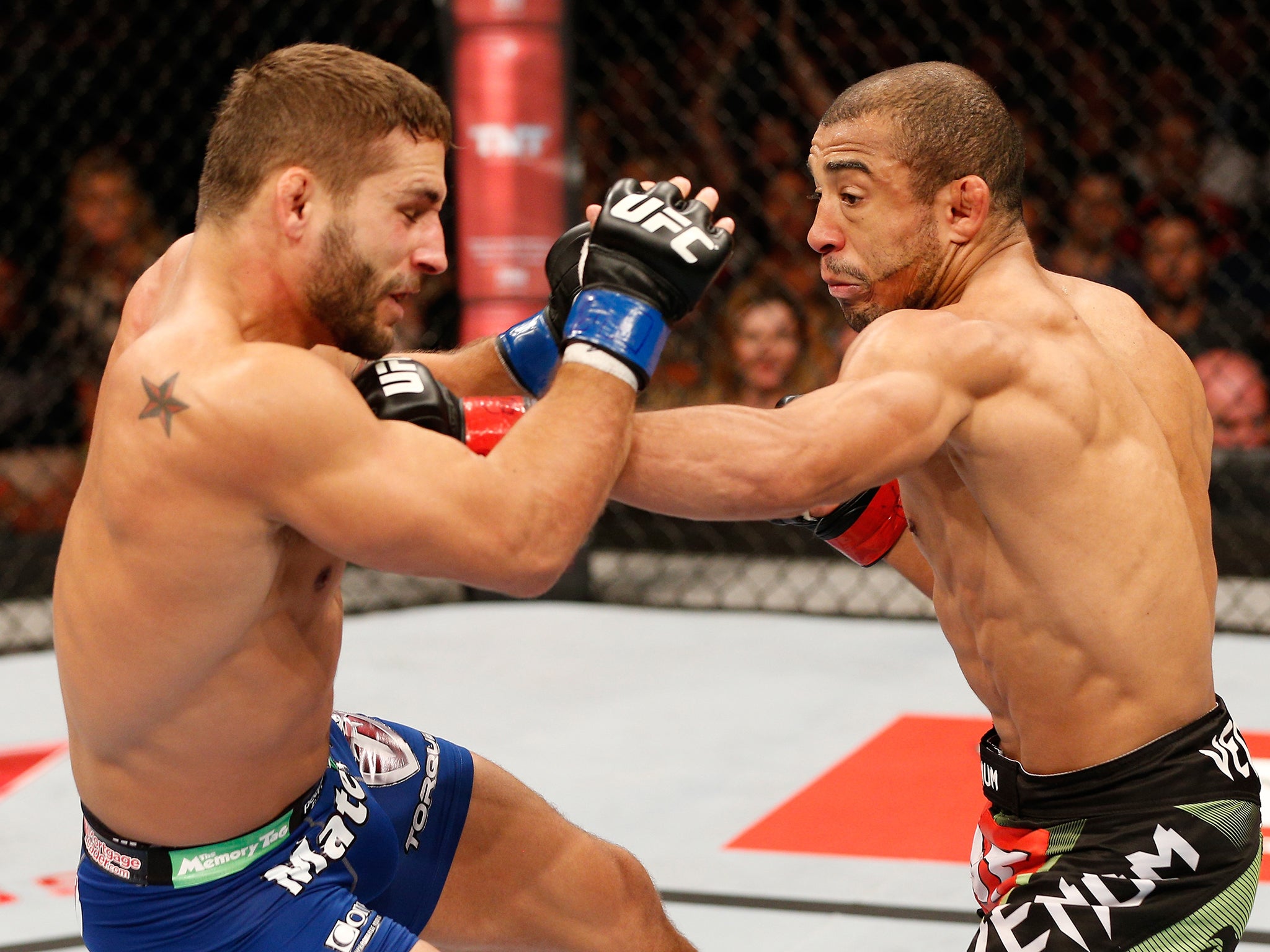 Jose Aldo punches Chad Mendes during UFC 179