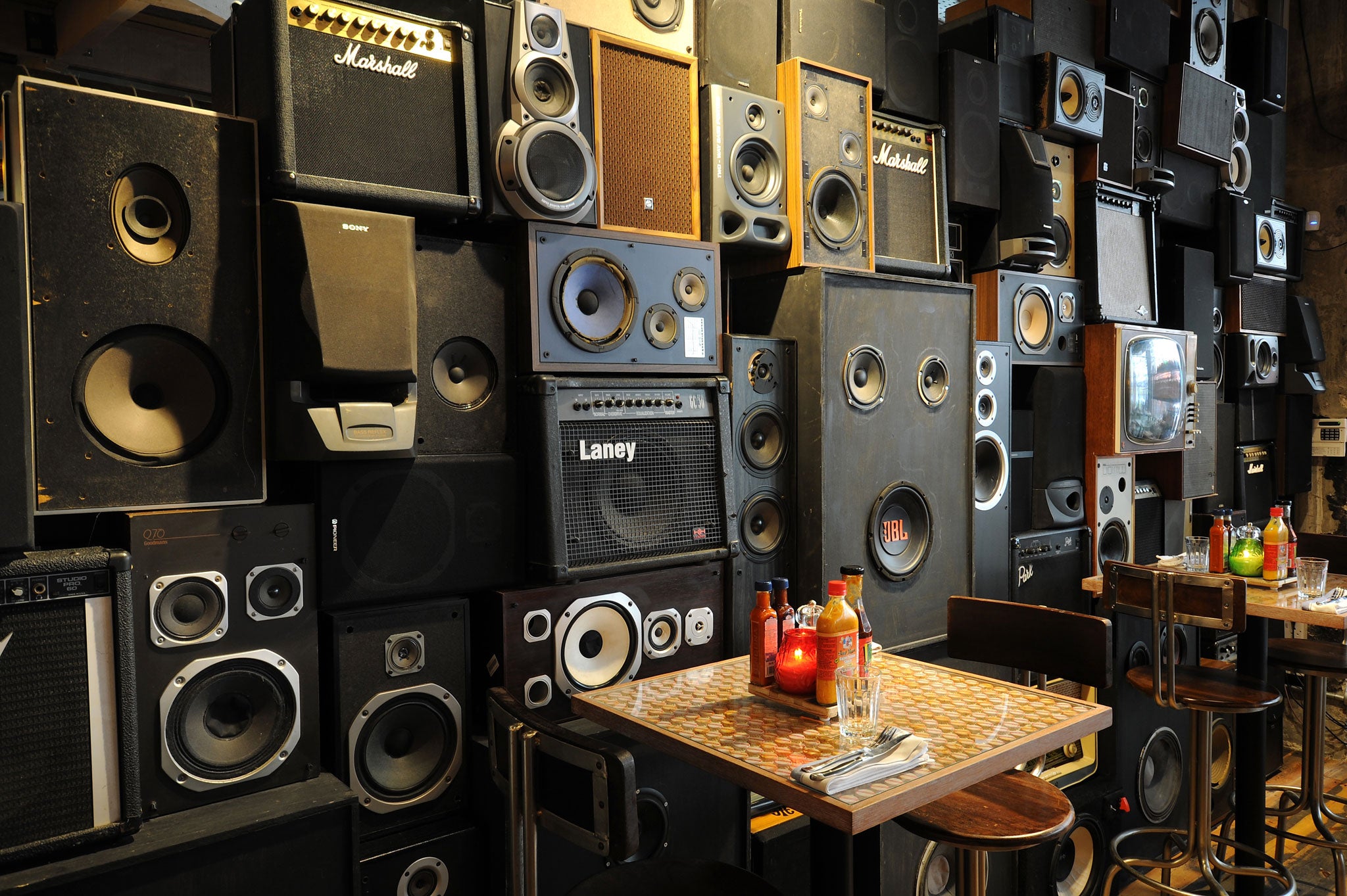The restaurant features a wall of old hi-fi speakers and amplifiers