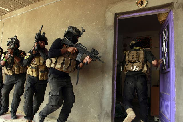 Iraqi special forces search a house yesterday after retaking Jurf al-Sakhar, north of
the Shia shrine at Karbala