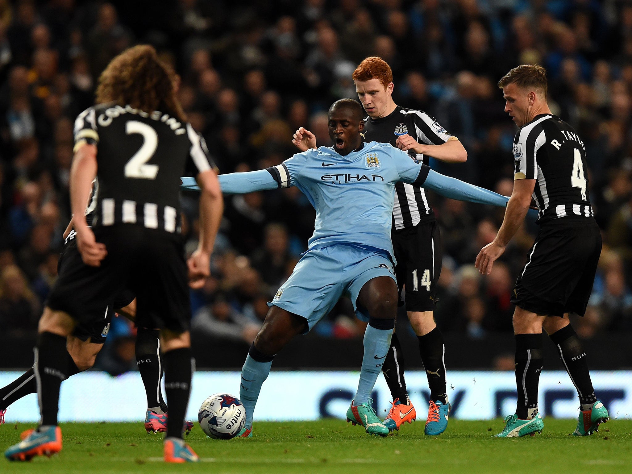 Yaya Touré struggles to escape the attentions of Newcastle players on Wednesday