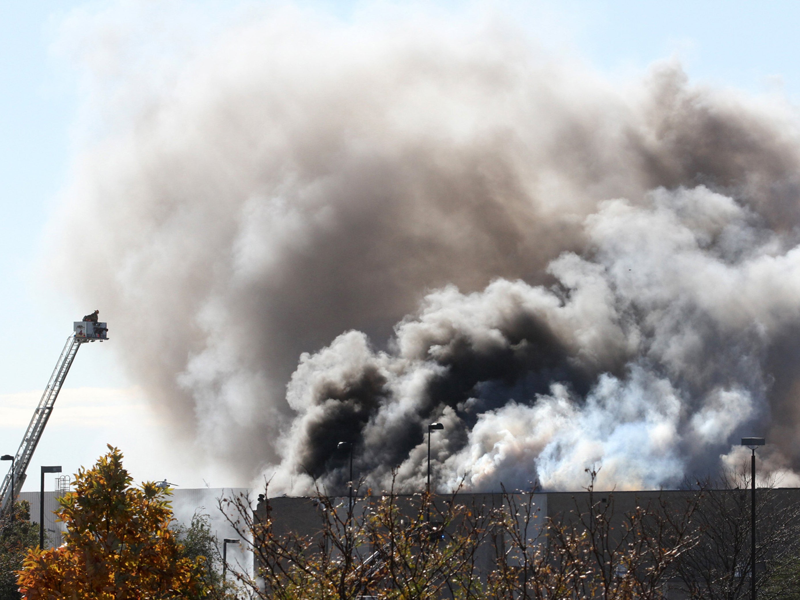 Smoke billows from a building at Mid-Continent airport in Wichita, Kansas, after a small plane crashed into it