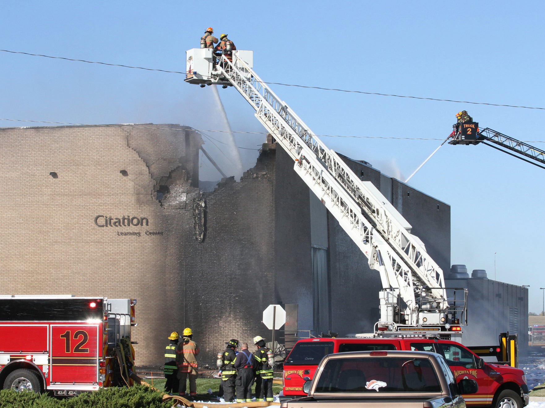 Fire-fighters battle to put out the fire caused by the plane crash