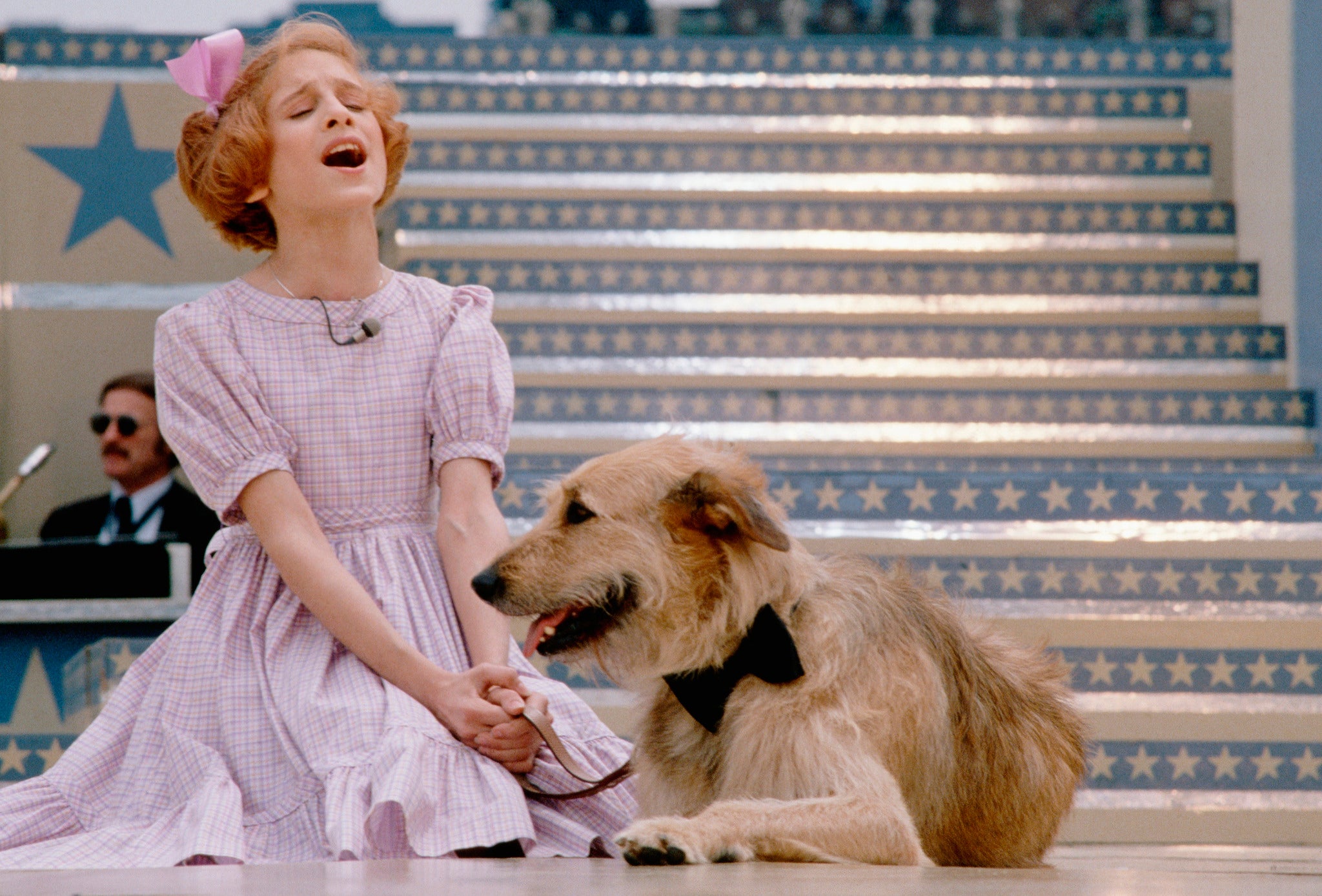 Actress Sarah Jessica Parker performs a scene with a dog in the musical Annie, 1979.
