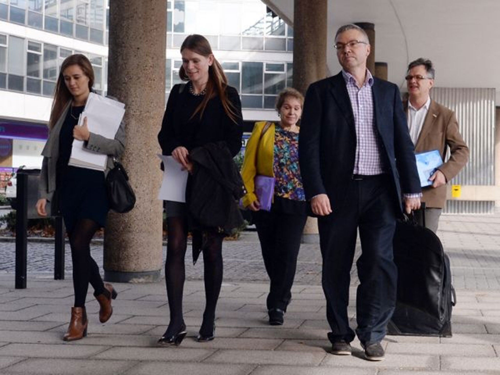 Representatives of child abuse victims arrive at a meeting in London