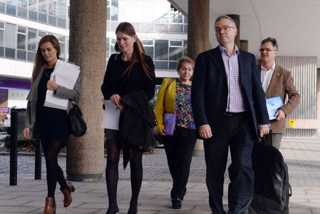 Representatives of child abuse victims arrive at a meeting in London