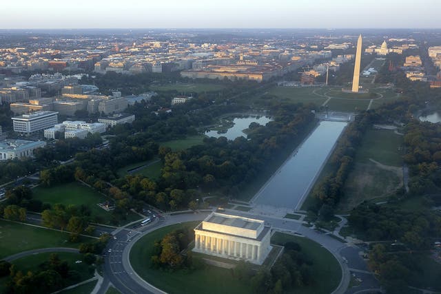 The skyline of Washington, DC, including the Lincoln Memorial, Washington Monument, US Capitol and National Mall, is seen from the air at sunset 
