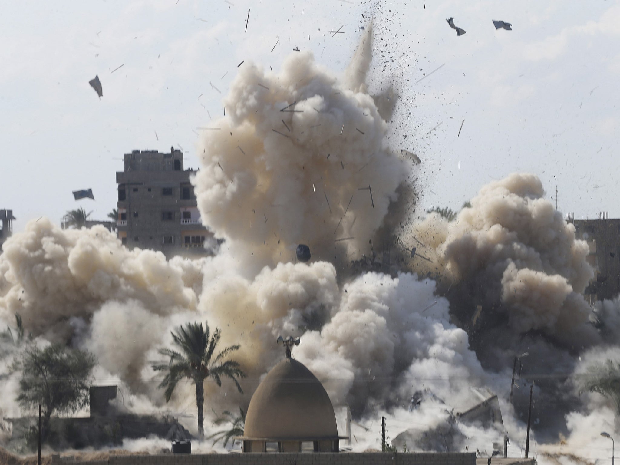 Smoke rises after a house was blown up during a military operation by Egyptian security forces in the Egyptian city of Rafah