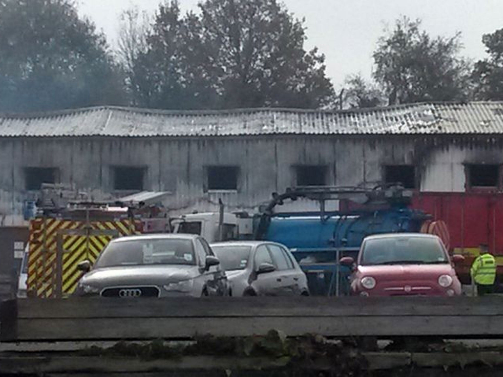 Smoke at the scene of a fire at a fireworks factory in Stafford, as rescue workers planned to begin their search for the missing people once the premises were deemed safe.