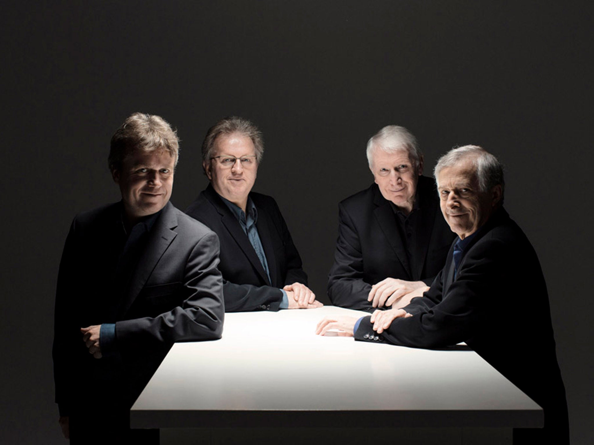 The Hilliard Ensemble: Four middle-aged gents in suits, singing in a row (Photo: Marco Borggreve/press image from Debra Boraston)