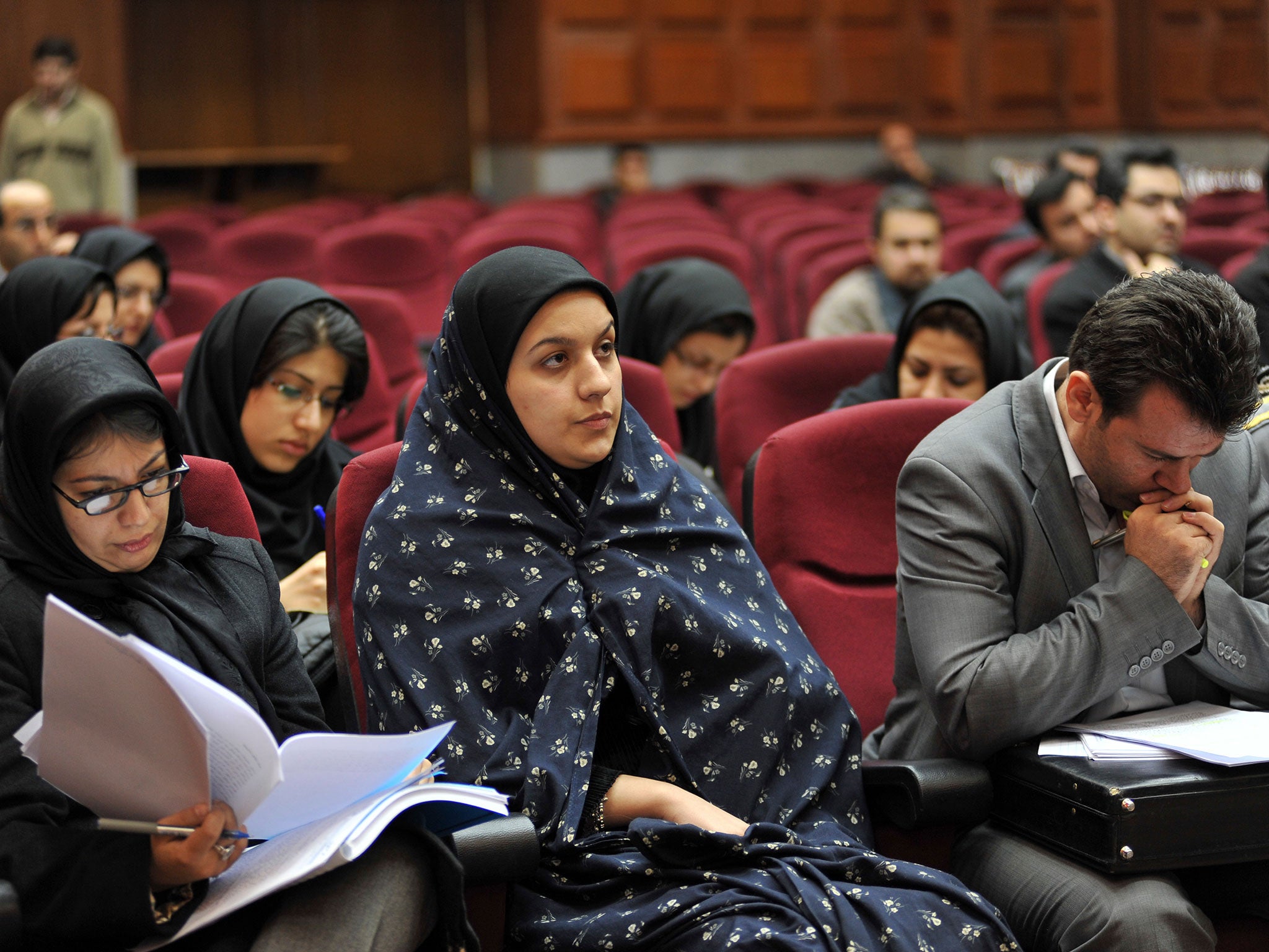 Iranian Reyhaneh Jabbari, center, sits while attending her trial in a court in Tehran, Iran. Jabbari was hanged on Saturday, Oct. 25, 2014, who was convicted of murdering a man she said was trying to rape her