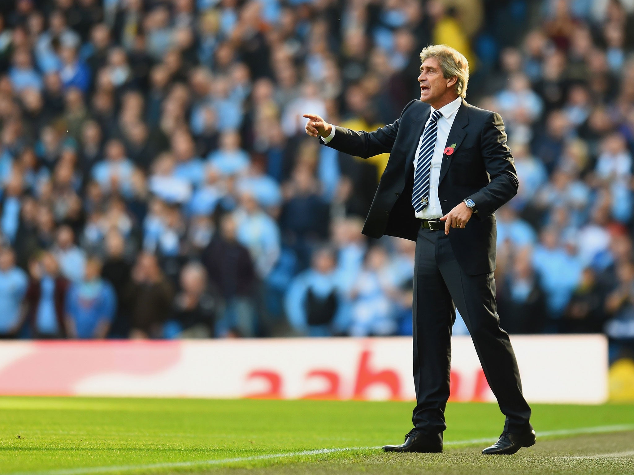 Pellegrini shouts instructions to his City players in the win over United